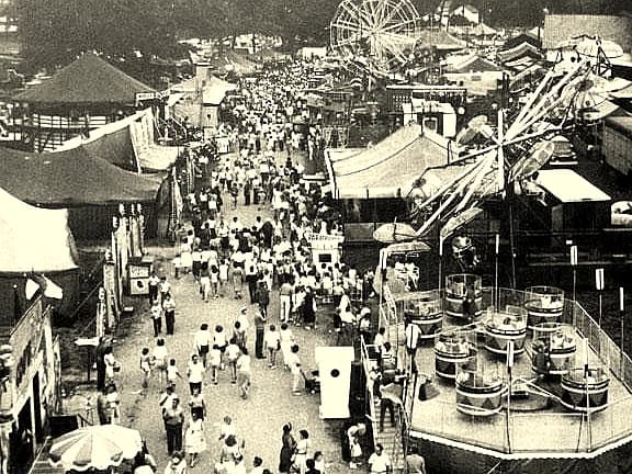 Historic aerial view of the West Tennessee State Fair midway, packed with fairgoers, rides, and vendor booths