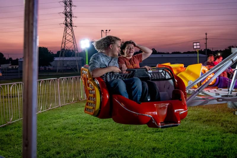 Carnival ride at sunset — pink and purple sky